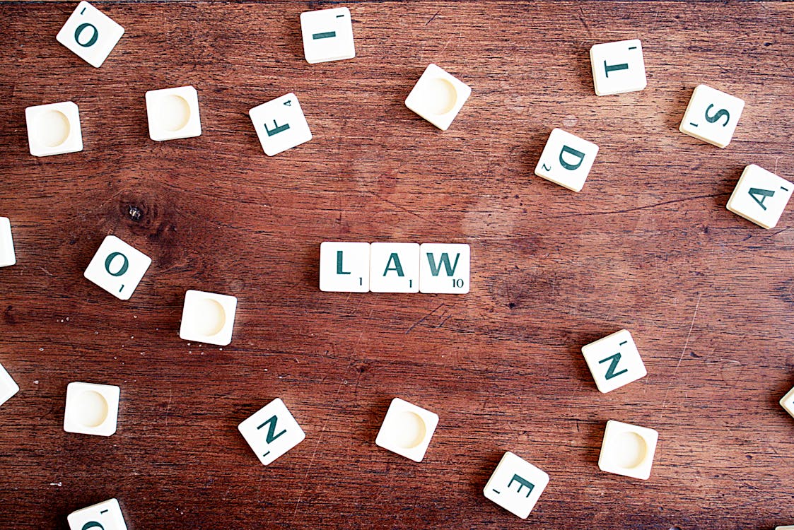 photograph of the word 'law' spelled on scrabble tiles